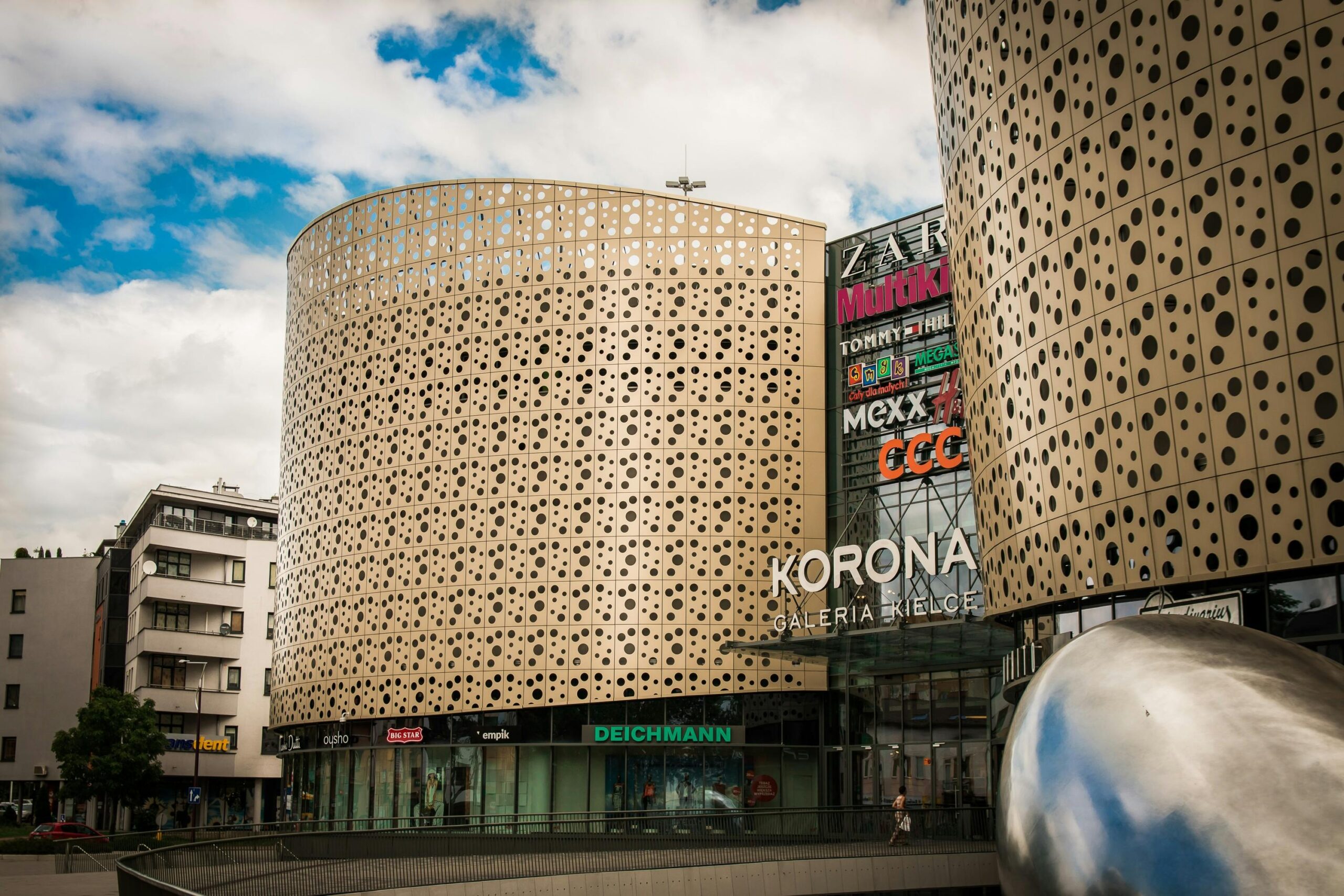A contemporary shopping mall, Galeria Korona in Kielce, featuring unique architectural design.